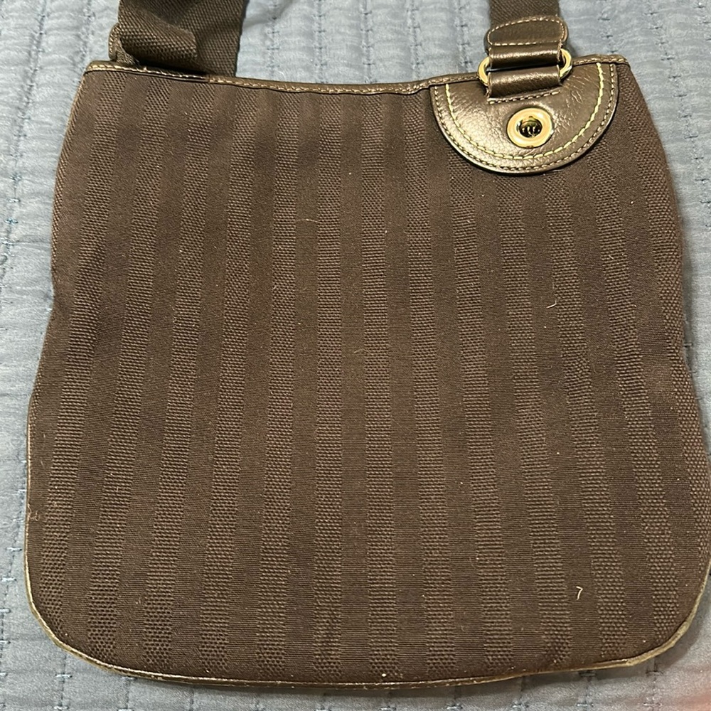 Black canvas/twill crossbody w adjustable strap and silver Hardwear. Lacoste